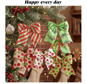 Variety of festive Christmas bows in red and green patterns hanging on a holiday tree.
