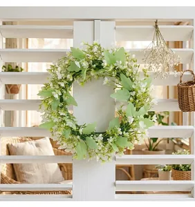 Elegant white floral and green leaf wreath hung on a white louvered door for home decor