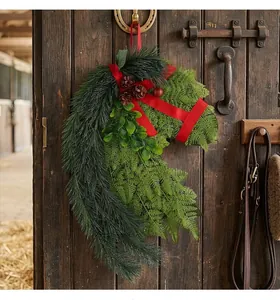 Close-up of a horse-head shaped Christmas wreath made of artificial pine and ferns