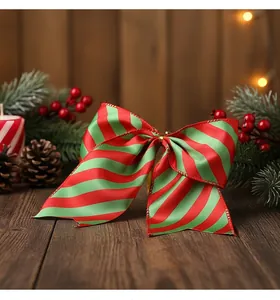 Close-up of red and green striped Christmas bow decoration on wooden background