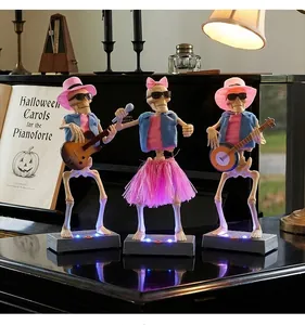 Detailed view of three animated Halloween skeleton band figures with LED light bases