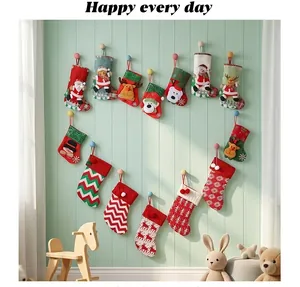 Various festive Christmas stockings arranged in a heart shape on a decorative wall.