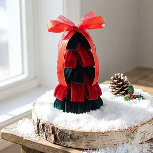 Handmade mini velvet Christmas tree desktop decoration with red bow on snowy wood base