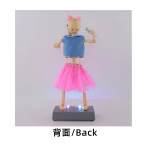 Back view of a musical electric Halloween skeleton toy with pink skirt and glowing lights