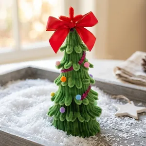Handmade mini chenille stem Christmas tree with red bow for DIY festive desktop decor