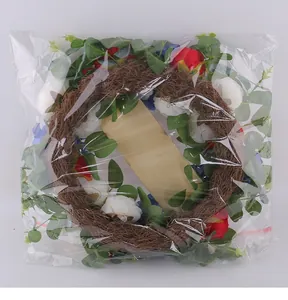 Red white and blue artificial floral wreath in clear protective plastic packaging for decor