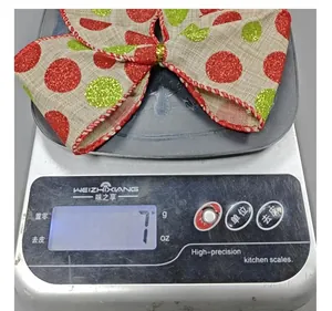 Detail shot showing the lightweight 7g red and green polka dot Christmas burlap bow.