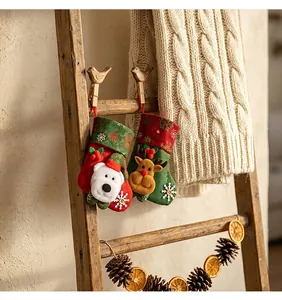 Detail showing plush Christmas stockings with polar bear and reindeer on a wooden ladder.