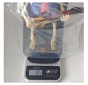 Weight measurement of the Halloween electric musical skeleton toy showing 385 grams