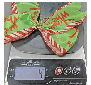 Macro view of a lightweight Christmas striped bow showing a weight of 4 grams on a digital scale