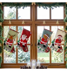 Festive Christmas stockings with 3D characters hanging on a rustic window frame decoration.