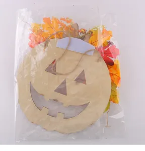 Detail view of a Halloween wooden pumpkin hanging sign with autumn leaves in packaging