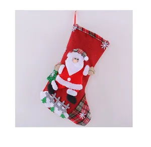 Detailed view of red burlap Christmas stocking featuring a 3D Santa Claus figure