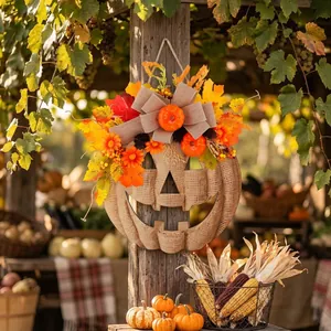 Handcrafted rustic wooden Halloween pumpkin door wreath with autumn leaves and burlap bow