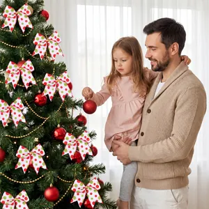 Festive red and green polka dot Christmas bows on tree with family decorating