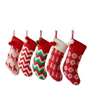 Set of five festive knit Christmas stockings with reindeer and snowflake patterns