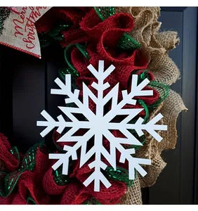 Macro detail of Christmas burlap wreath with large white snowflake ornament