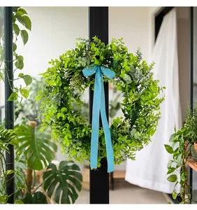 Realistic green leaf wreath with sky blue velvet ribbon for spring home wall decor.