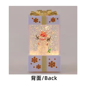 Detailed rear view of a Christmas gift box snow globe lamp featuring a snowman inside