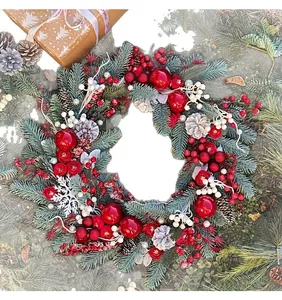 Close-up of festive Christmas wreath featuring pine branches, red baubles and berries