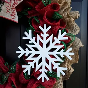 Festive red and green burlap Christmas wreath with a large white snowflake ornament.
