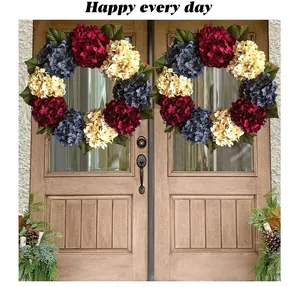 Two decorative red white and blue hydrangea wreaths hanging on a wooden double door
