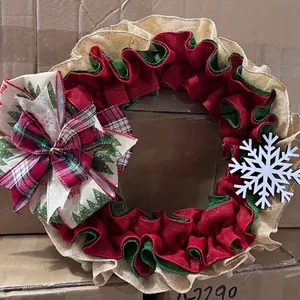 Festive Christmas burlap wreath featuring red and green ruffles, a large bow, and snowflake.