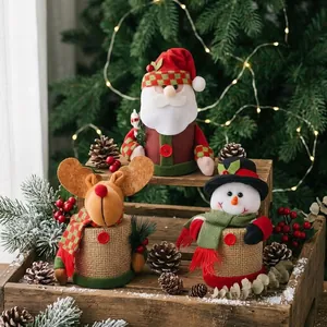 Festive Christmas gift jars featuring Santa, Snowman, and Reindeer characters on wood.