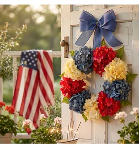 Patriotic red white and blue hydrangea wreath with a large blue bow for Independence Day
