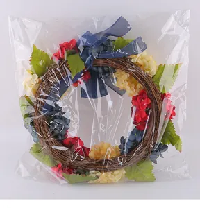Patriotic Independence Day hydrangea wreath with blue ribbon in clear plastic packaging
