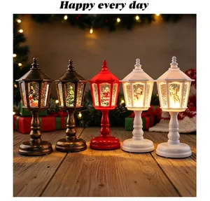 Detailed view of four colorful decorative Christmas snow globe lanterns on a wooden table