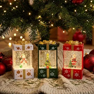 Set of 3 glowing Christmas gift box snow globes with Santa and snowman under tree