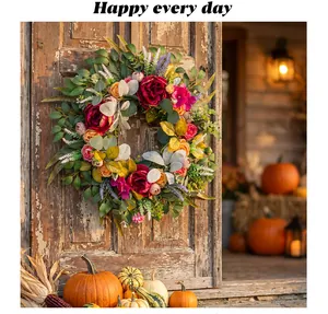 Autumn peony wreath decoration with eucalyptus leaves hanging on a rustic wooden door