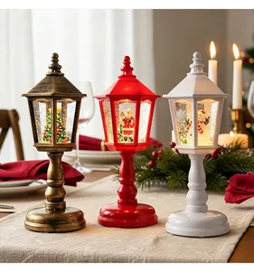 Three festive Christmas lantern snow globes featuring Santa, a snowman, and a tree on a table.