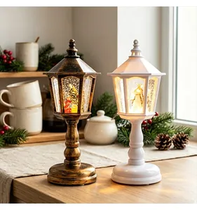 Vintage Christmas lantern snow globes with warm LED light in bronze and white styles.