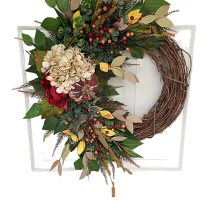 Autumn wreath with red hydrangea, pumpkin, berries and green leaves on white frame background