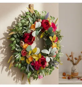 Detailed view of an autumn harvest peony wreath with red flowers and lush foliage