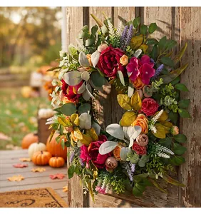 Beautiful vibrant autumn harvest peony wreath displayed on a rustic weathered wooden door
