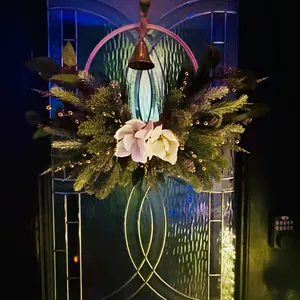 Christmas magnolia wreath with pine needles and vintage bronze bell hanging decoration
