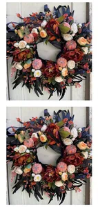Detailed view of an elegant autumn wreath featuring black leaves and colorful mini pumpkins