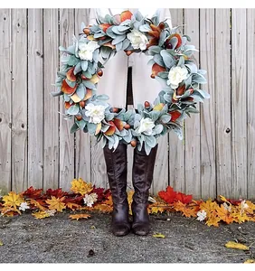 Macro detail of autumn wreath featuring lamb's ear leaves, white flowers and acorns
