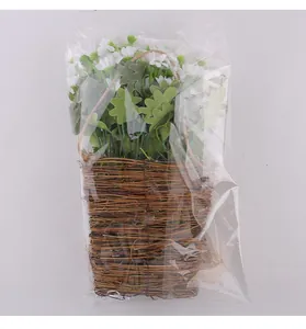 White artificial daisy flower arrangement in a woven rattan wall basket for home decor