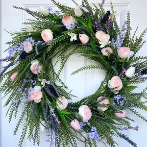 Detailed close-up view of vibrant artificial spring wreath with pink roses and lavender