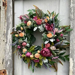 Rustic autumn harvest wreath with colorful peonies on a vintage wooden door decor