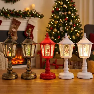Five decorative Christmas lantern snow globes with warm LED lighting on a festive tabletop