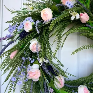 Close-up of spring floral wreath with pink roses and purple lavender door hanging decor.