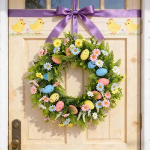 Colorful Easter floral wreath with speckled eggs and daisies on a wooden front door