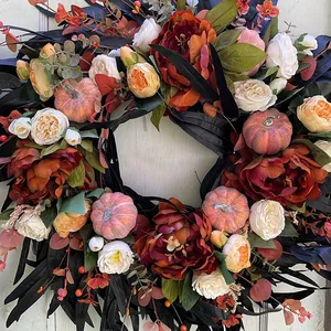 Autumn floral wreath with black leaves, pumpkins and peonies for front door decor