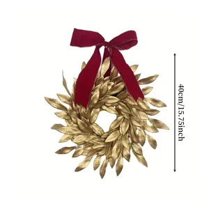 Detailed view of 40cm golden leaf Christmas wreath with a large red velvet bow decoration