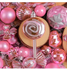 Nahaufnahme von rosa glitzernden Christbaumkugeln in Lollipop- und Herzform für Feste